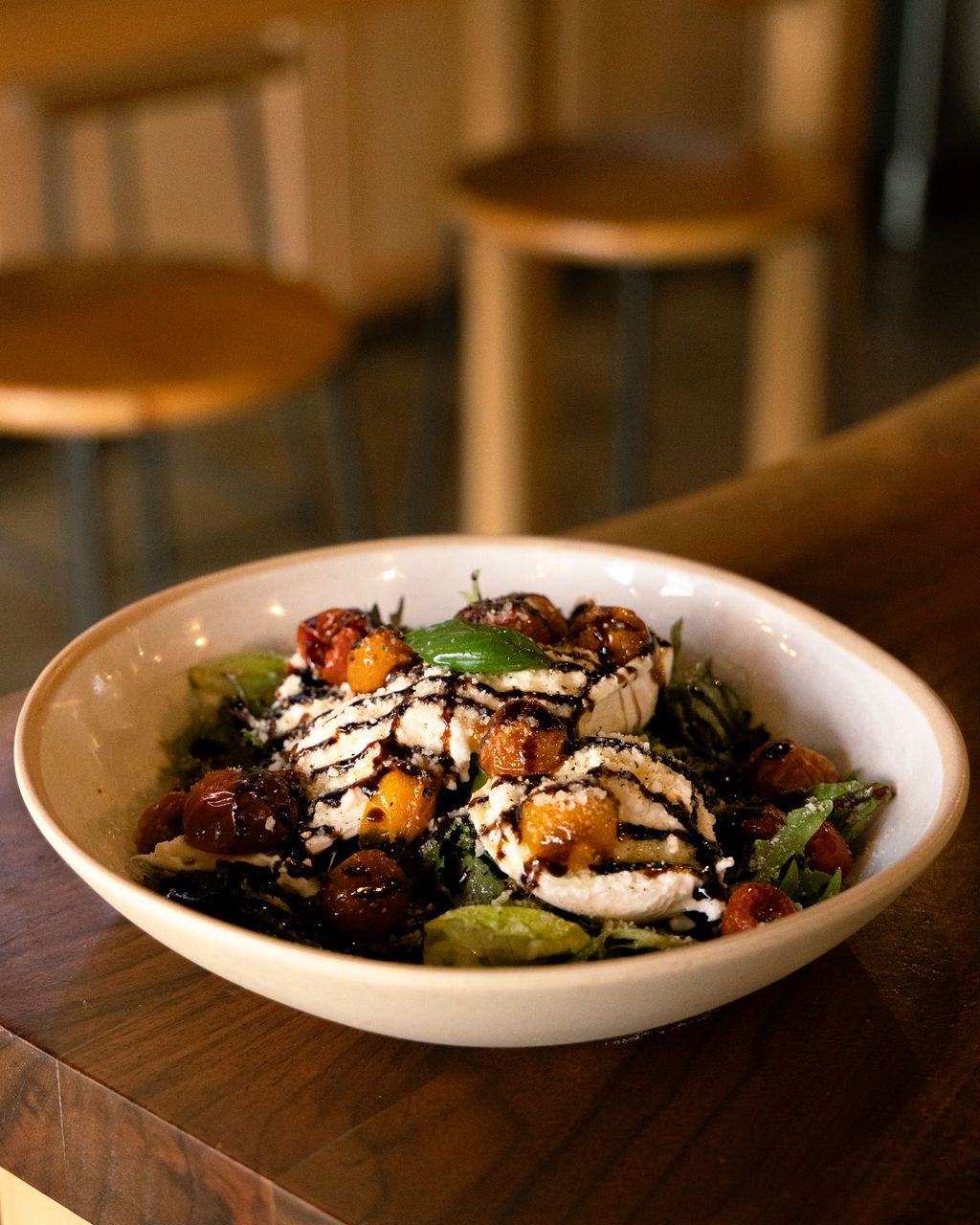 A burrata salad with roasted tomatoes and balsamic