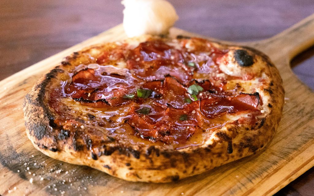 A wood-fired pizza fresh from the live fire