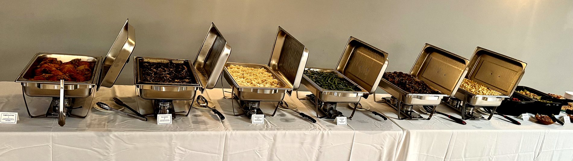 Full buffet line of chafing dishes ready for service at a wedding